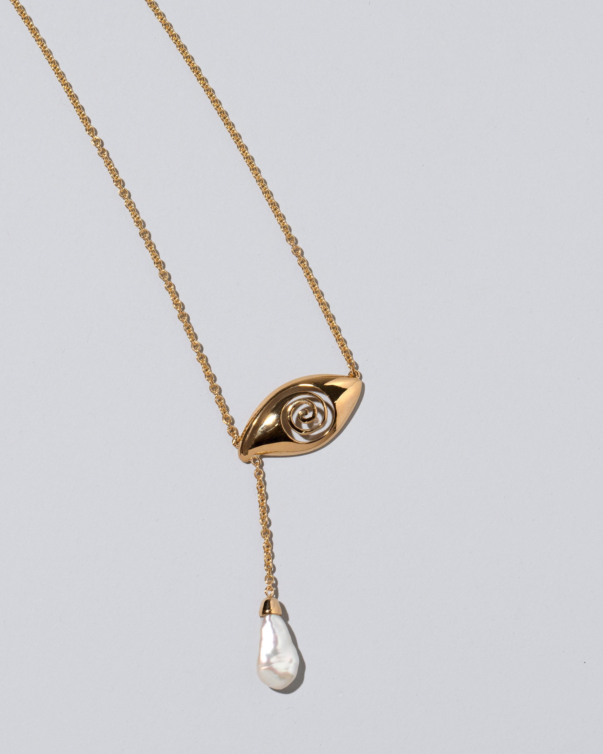 Pearl State Shifter Necklace on light color background.