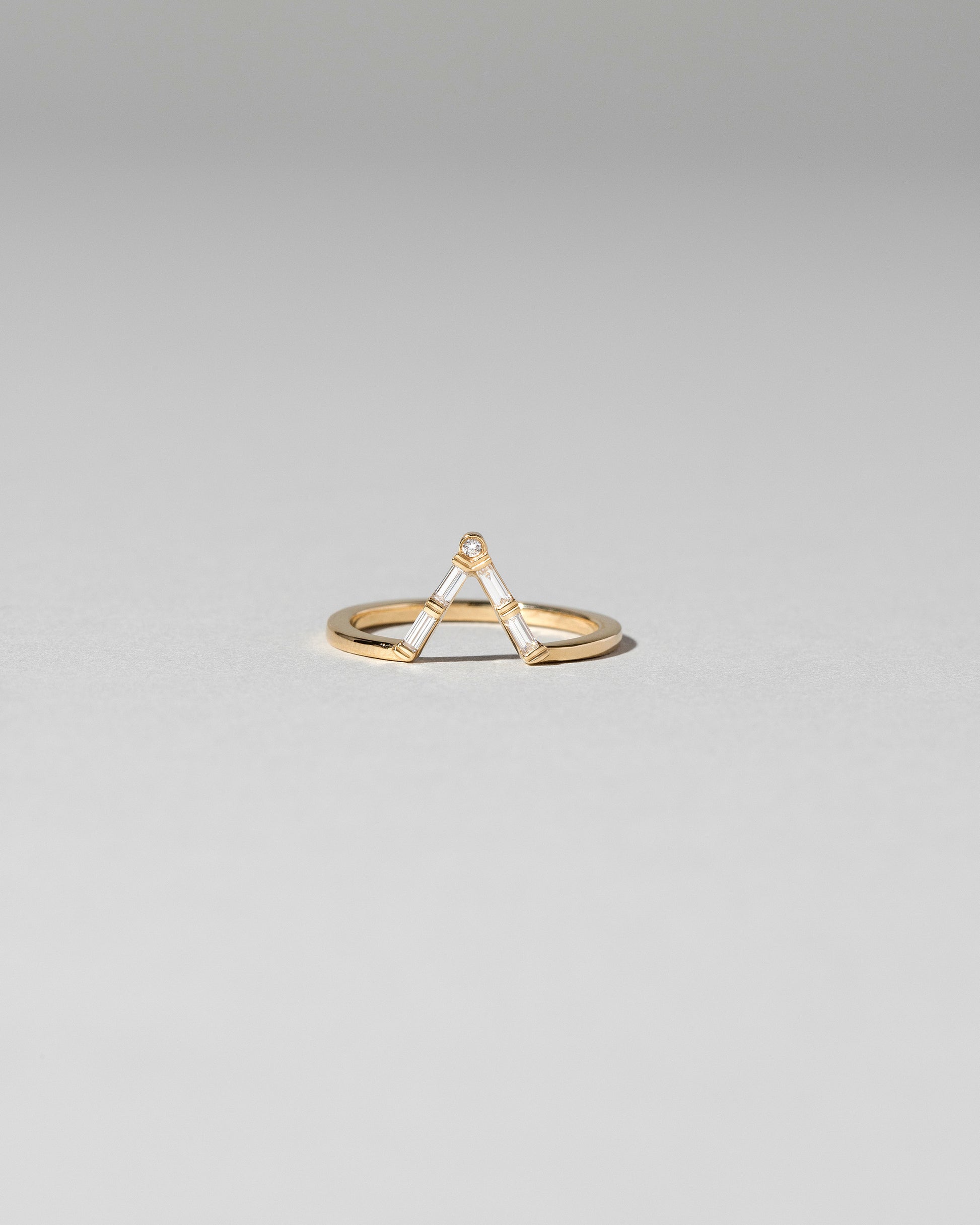 Gold Baguette Triangle Band on light color background.
