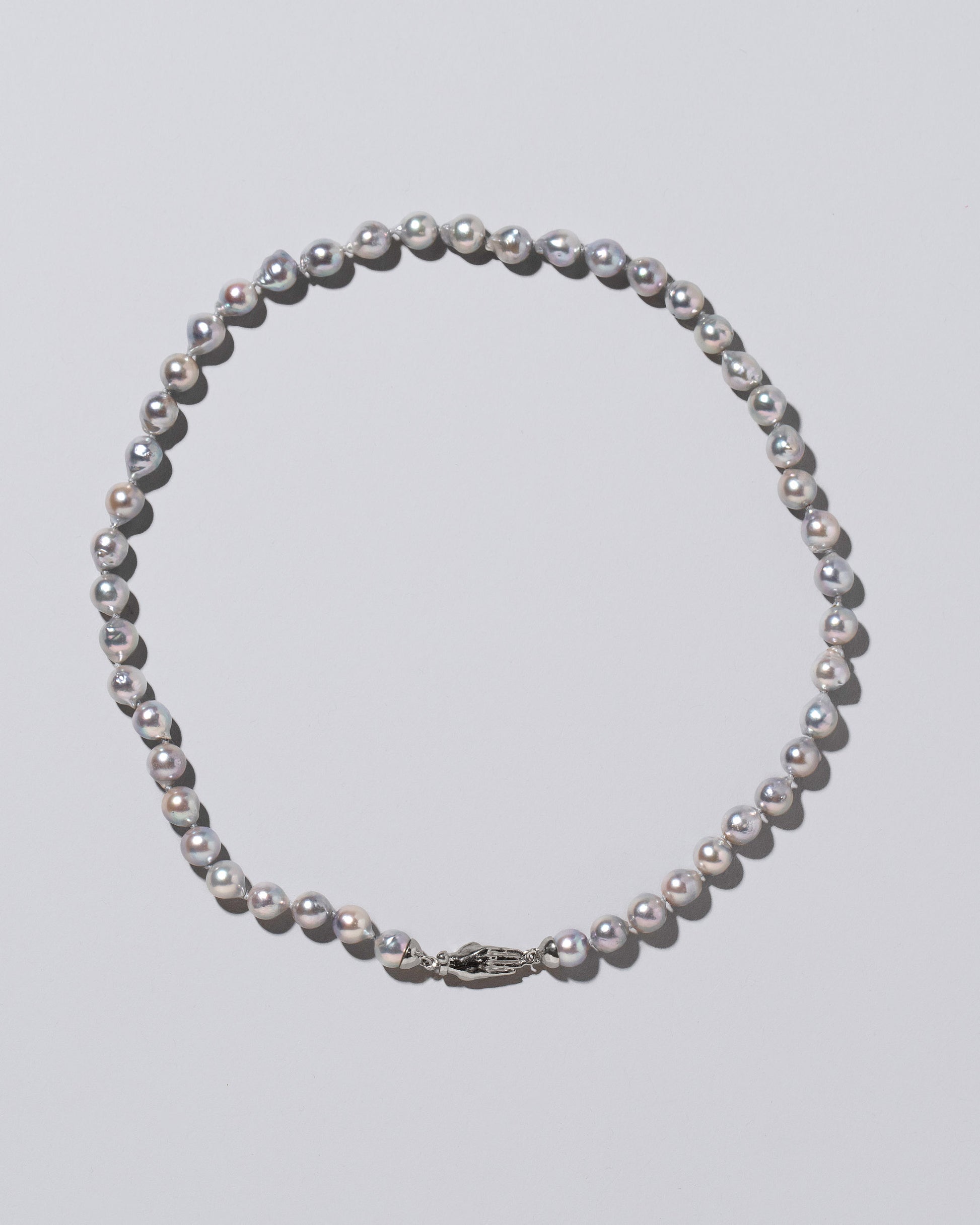 Blue Pearl & White Gold Union Pearl Necklace on light color background.