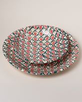 Closeup details of the Morgan Levine Spade Pasta Bowl and Morgan Levine Spade Platter on light color background.