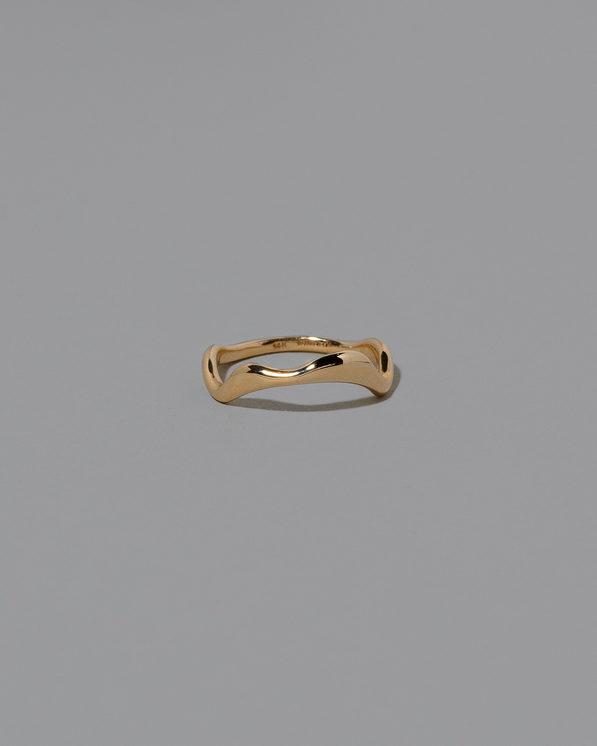 Gold Thin Fluctuating Band on light color background.