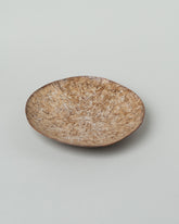 Closeup details of the Namu Home Goods Caramel Mini Maple Wood Whittled Plate on light color background.