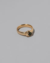 View from the side of the Green Sapphire Level Ring on light color background.