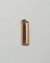 Pearce Objects Cast Bronze Lighter on light color background.
