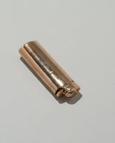 Closeup details of the Pearce Objects Cast Bronze Lighter on light color background.