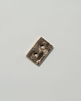 Pearce Objects Cast Bronze Mini Cassette Tape on light color background.