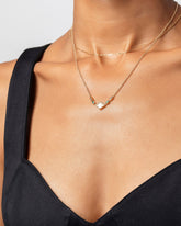 Petite Diamond Cut Chain Necklace and Radial Abstraction Necklace on model.
