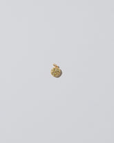 Mini Macaron Charm - Diamond Pavé Pistachio on light color background.