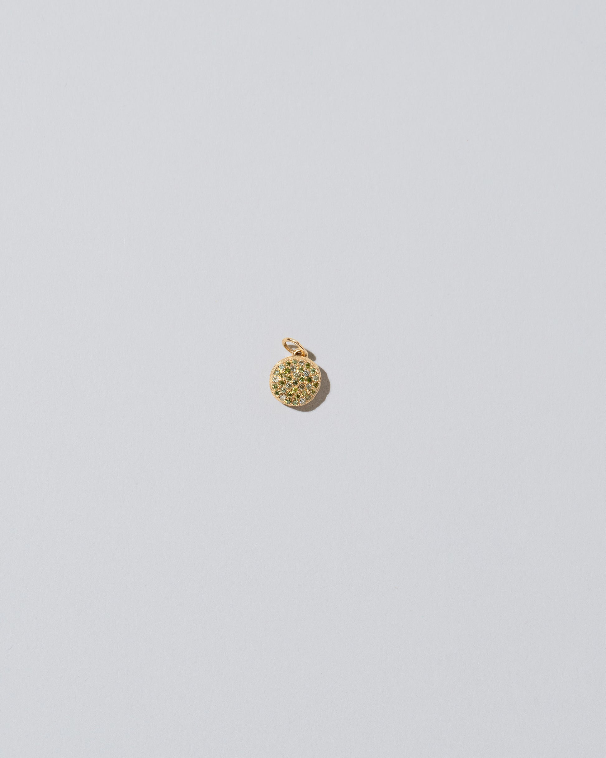 Mini Macaron Charm - Diamond Pavé Pistachio on light color background.