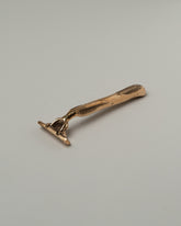 Pearce Objects Cast Bronze Razor on light color background.
