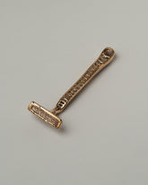 View from the back of the Pearce Objects Cast Bronze Razor on light color background.
