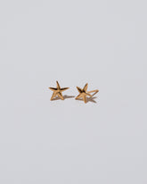 Verve Five Point Star Stud Earrings on light color background.