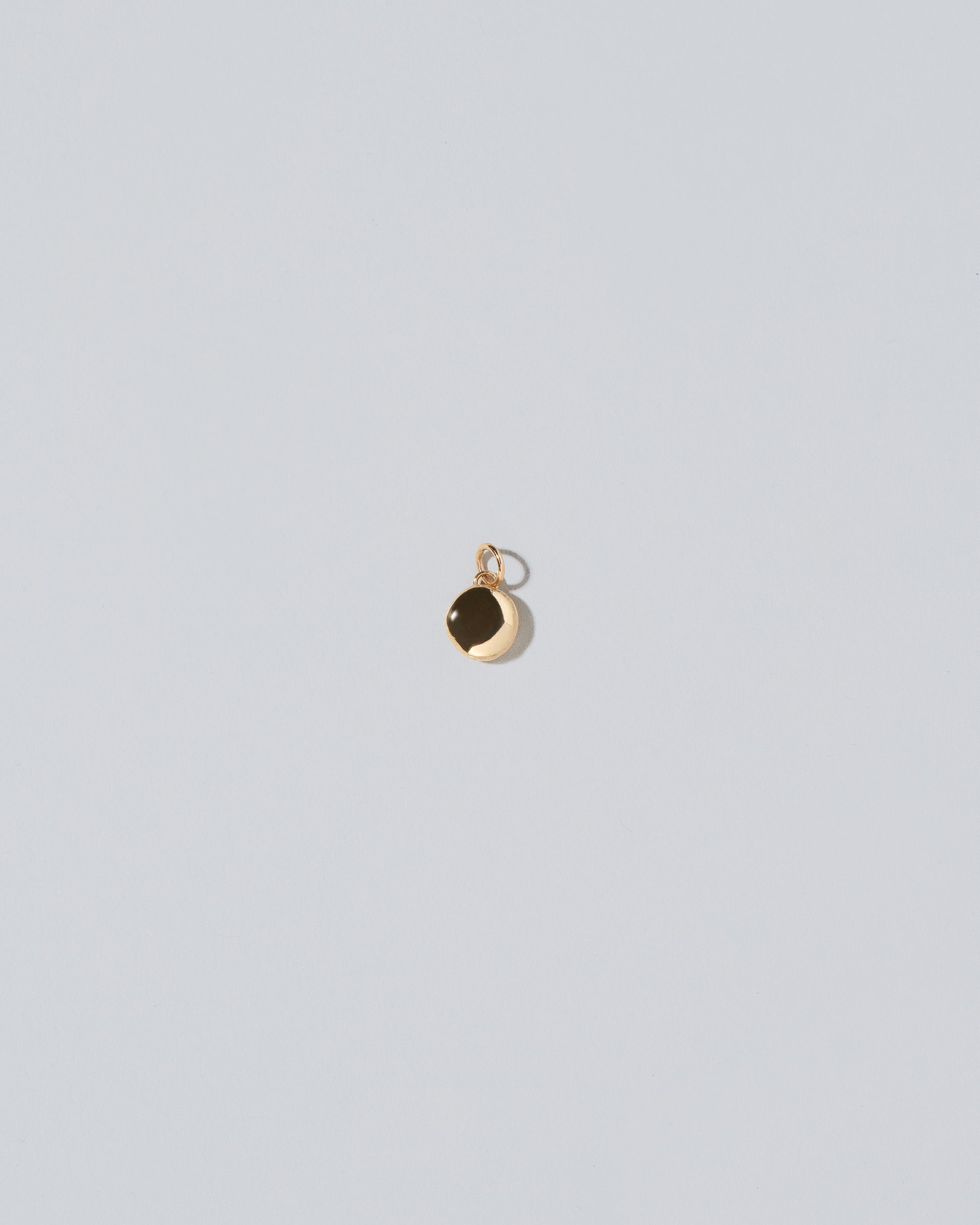 Mini Macaron Charm - 14k Gold on light color background.