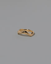 View from the side of the Gold Wide Fluctuating Band on light color background.