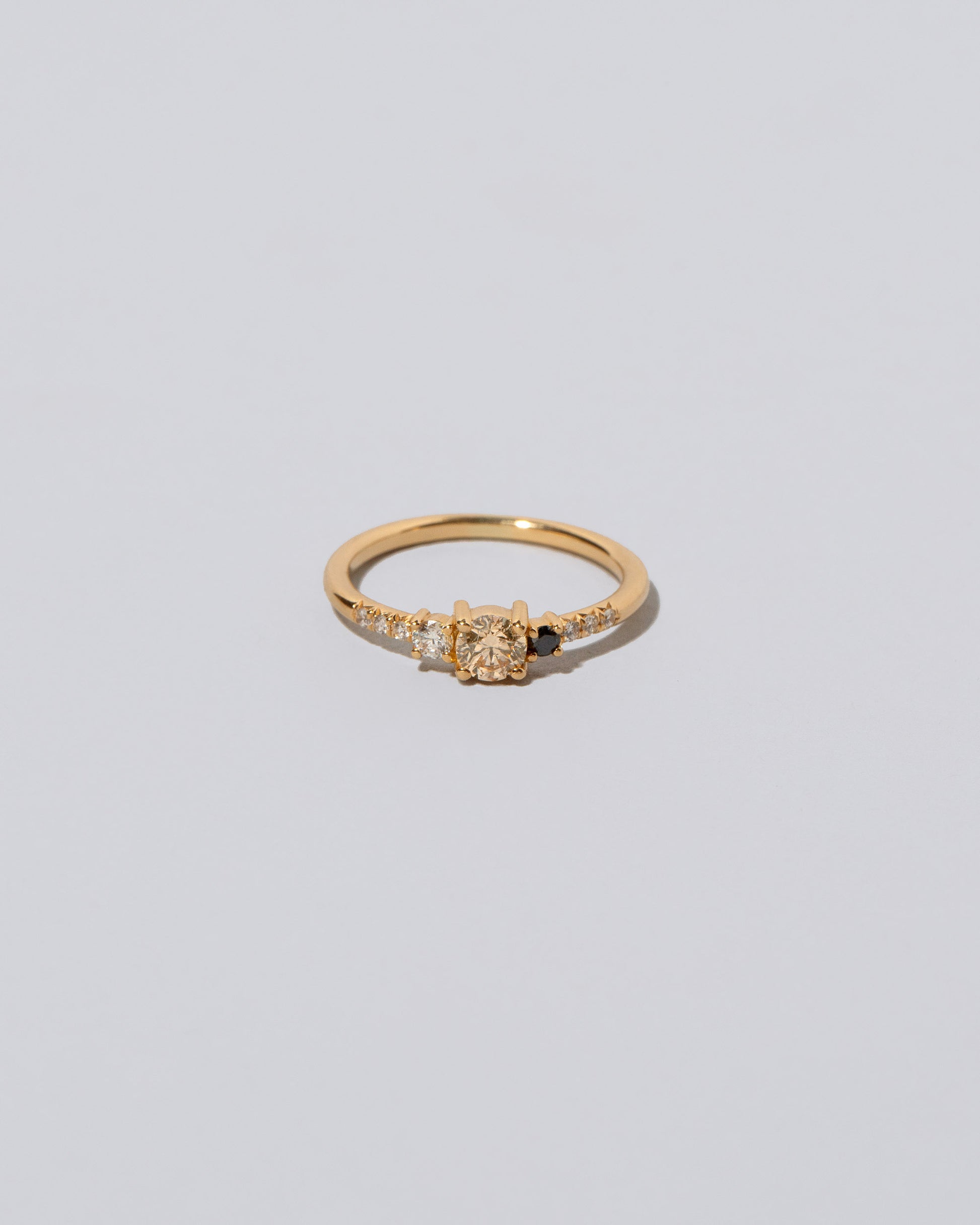 Champagne & Black Diamond Patira Ring on light color background.
