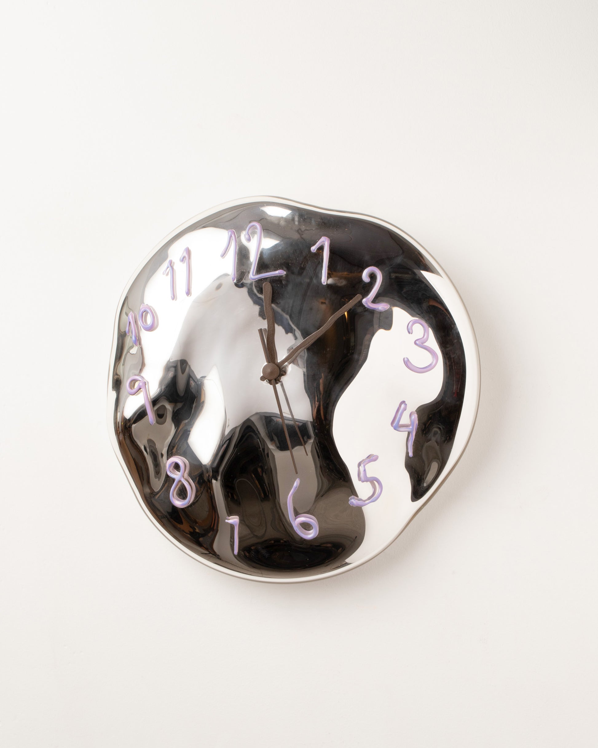 Silje Lindrup Brown Hands Lavender Glass Wall Clock on light color background.