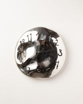 Silje Lindrup Black Hands Black Glass Wall Clock on light color background.