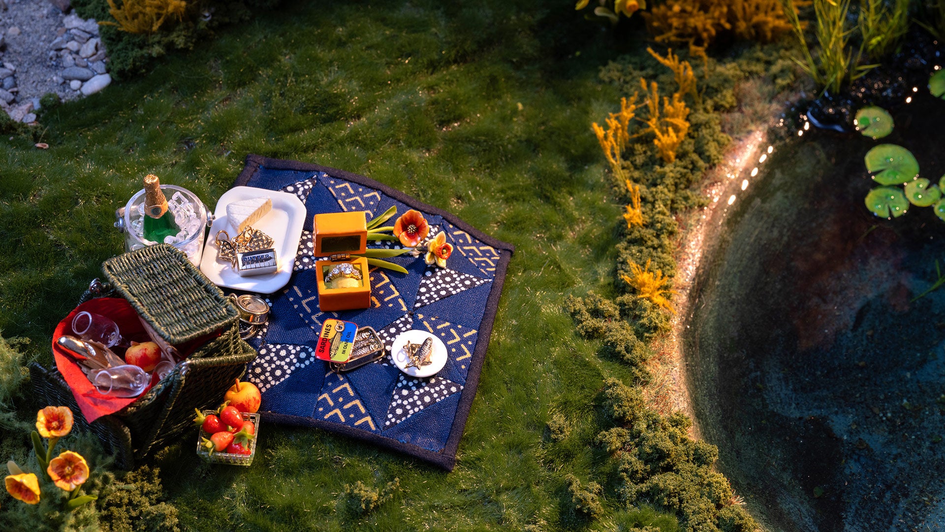 Small Pleasures charms on a blue blanket.