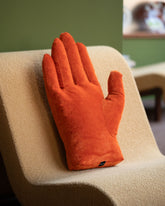 Styled image featuring the Sohn Right Persimmon Chenille Soft Sculpture Hand Pillow.