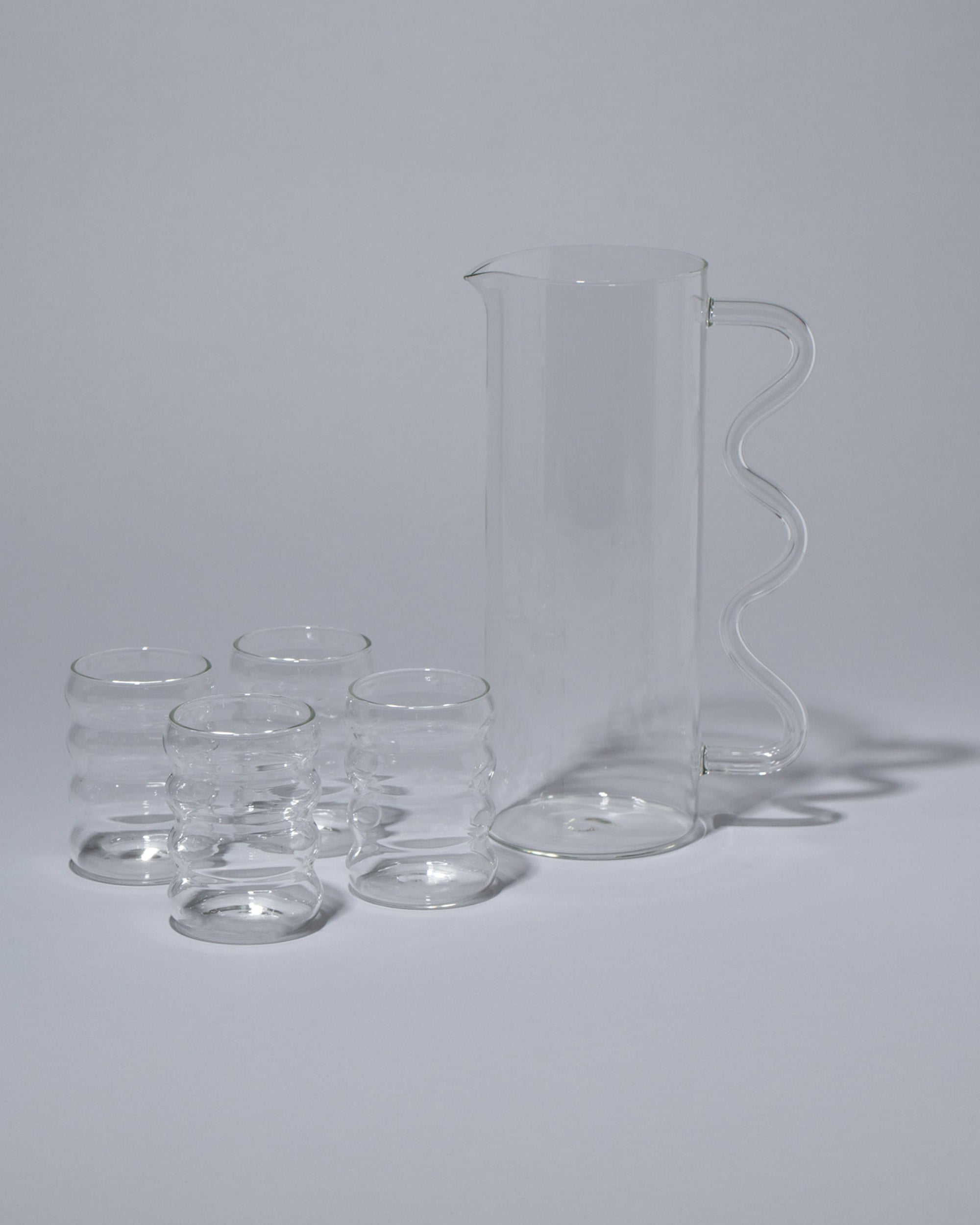 http://mociun.com/cdn/shop/files/SophieLouJacobsen_Drinking__WavePitcher-ClearwithClearHandle_66.2108__RippleCup-Single-Small_Clear_66.2116__1.jpg?v=1699996795