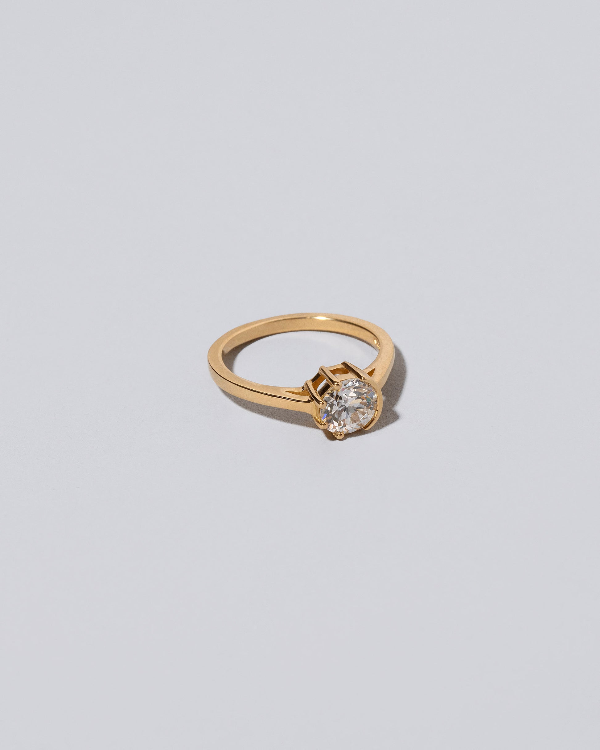 View from the side of the White Diamond Sun & Moon Ring on light color background.