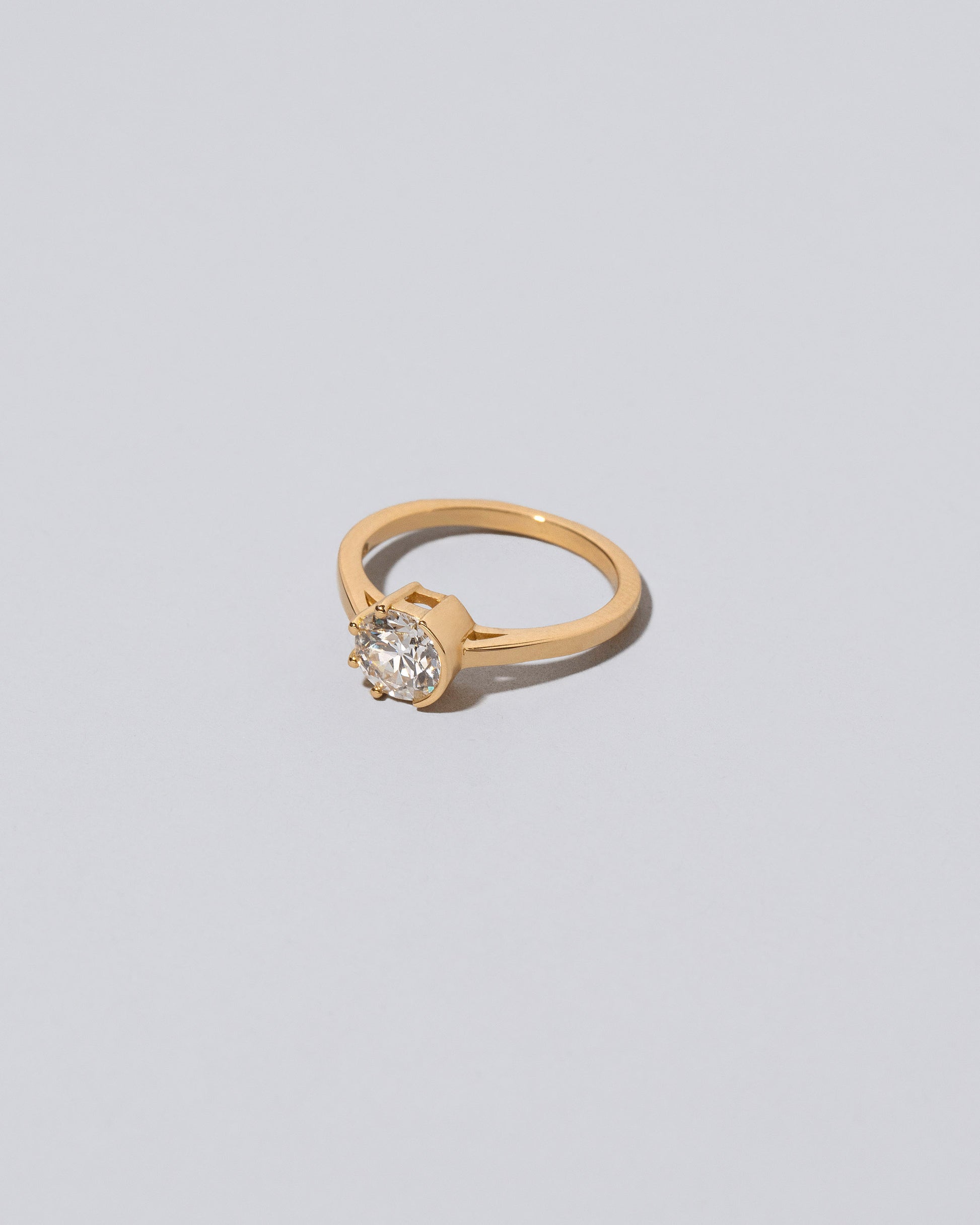 View from the side of the White Diamond Sun & Moon Ring on light color background.
