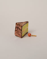 Suzanne Sullivan Piece Of Cake & Cherry Not On Top on light color background.