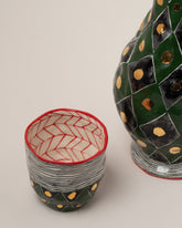 Closeup details of the Suzanne Sullivan Fix A Rendezvous Carafe & Cup on light color background.