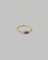 View from the side of the Blue Sapphire Teardrops Ring on light color background.