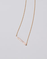 Stick Pearl Necklace on light color background.