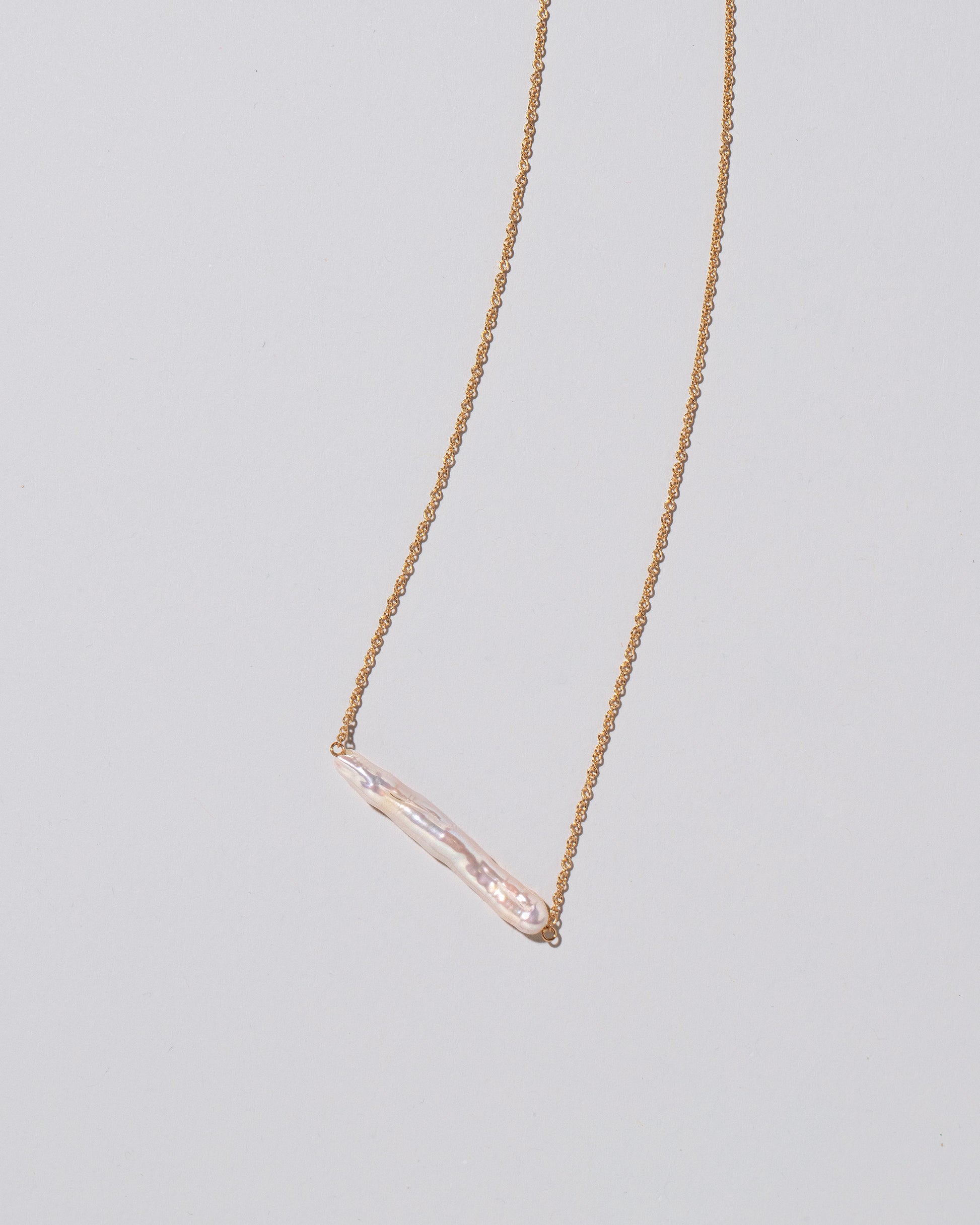 Stick Pearl Necklace on light color background.