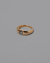 View from the side of the Bicolor Sapphire Venus Ring on grey color background.