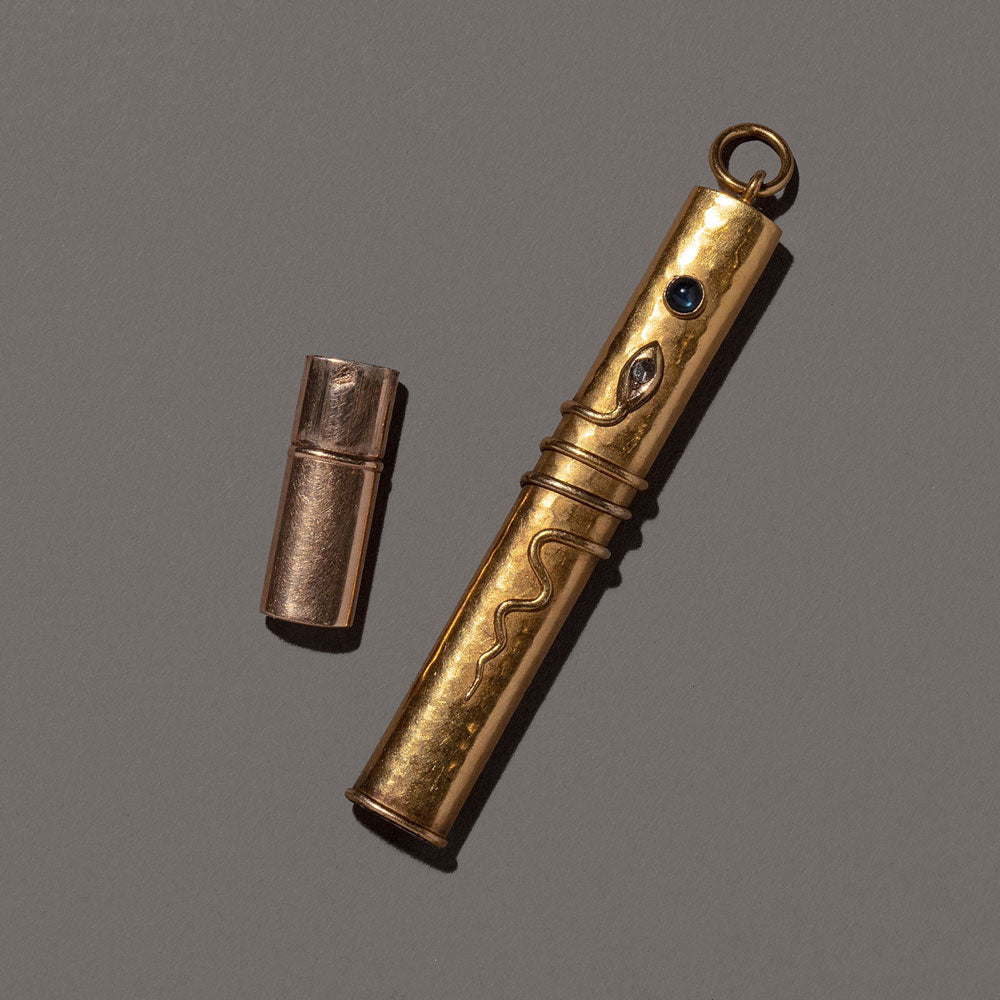 product_details::Detail view of the Antique & Vintage Egyptian Revival Pencil Holder Pendant on light color background.