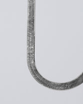 Silver Herringbone Chain on light color background.