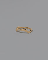 View from the side of the Gold Thin Fluctuating Band on light color background.