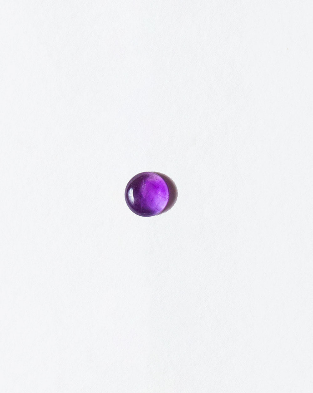 Amethyst cabochon on light color background.