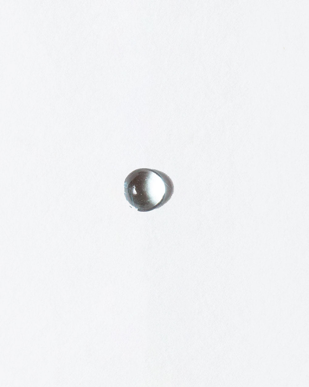Moonstone cabochon on light color background.
