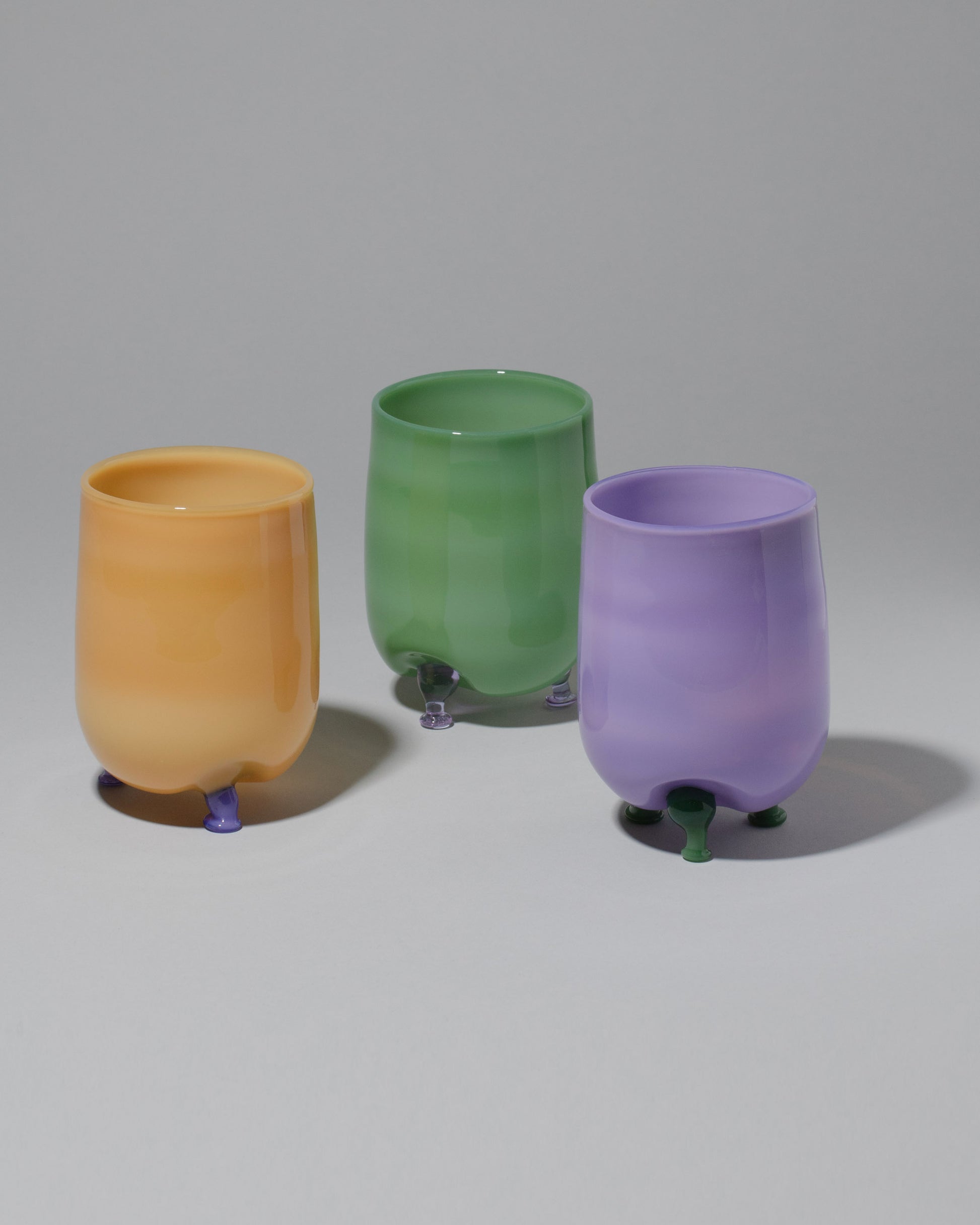 Group of Ornamental by Lameice Mint & Lilac, Violet & Mint and Topaz & Violet Opaque Eye Candy Cocktail Glasses on light color background.