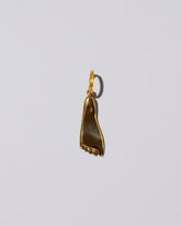 Carl Auböck Brass Foot Keyring on light color background.