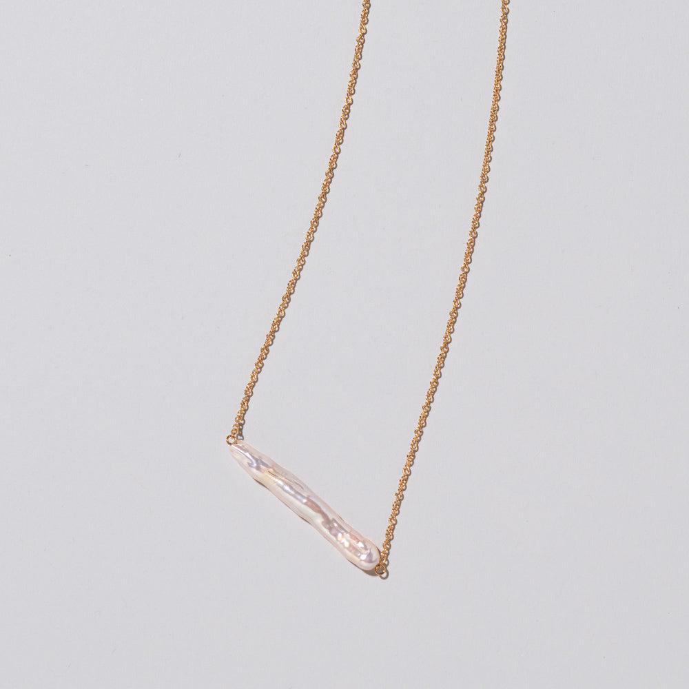 product_details::Stick Pearl Necklace on light color background.