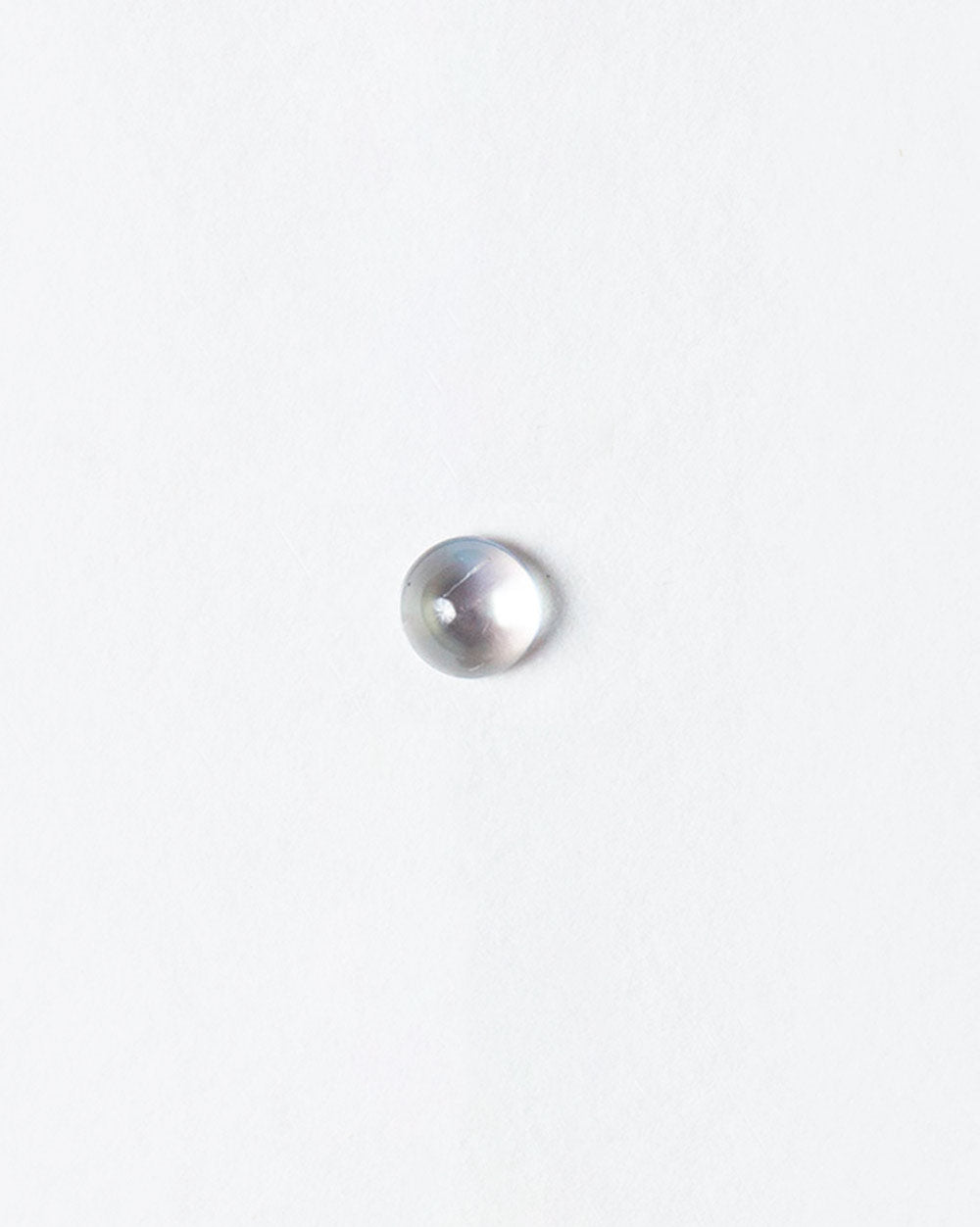 Aquamarine cabochon on light color background.