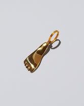 View from the side of the Carl Auböck Brass Foot Keyring on light color background.