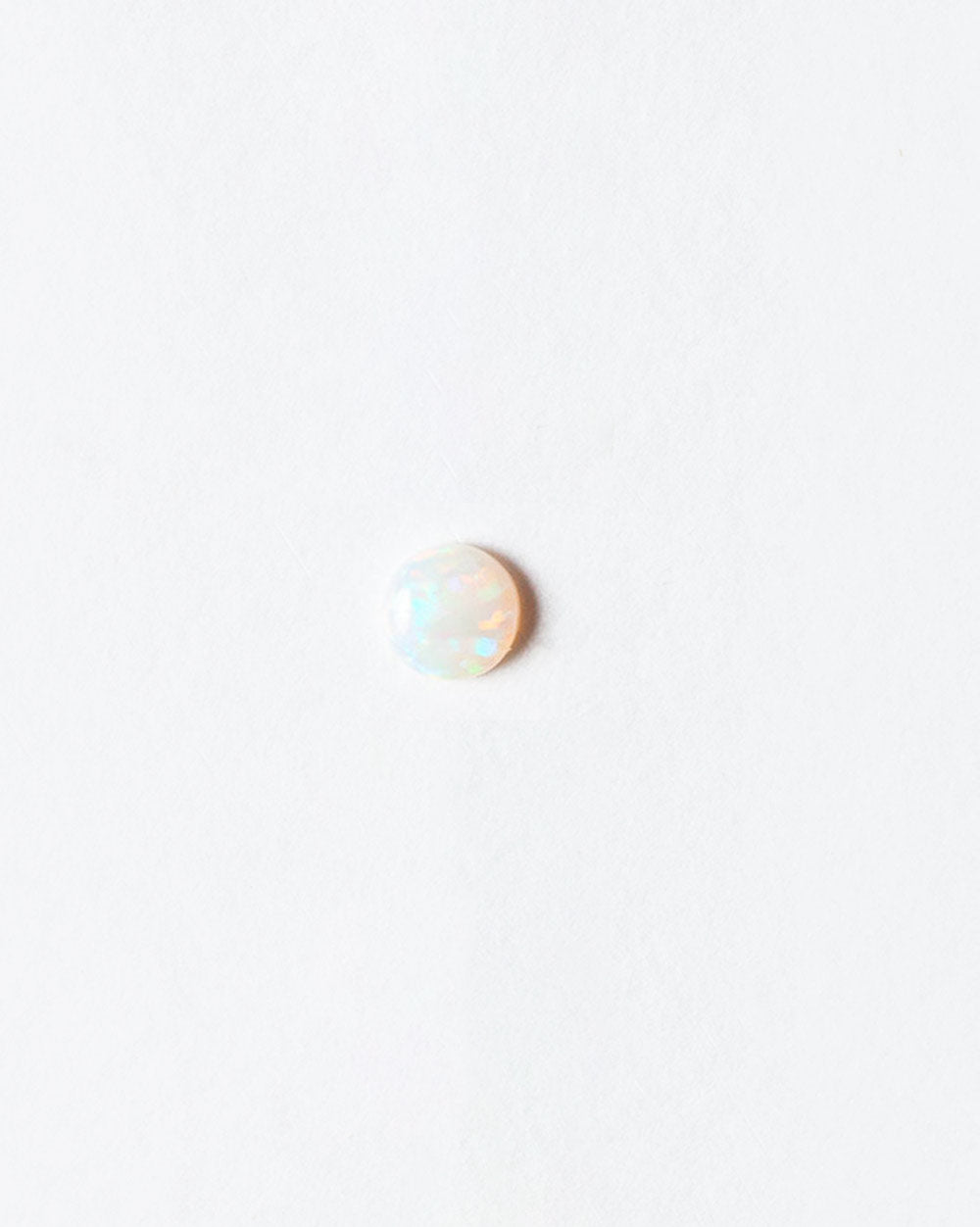 Opal cabochon on light color background.