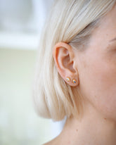 Diamond and Sapphire Birthstone Level Stud Earrings on model.