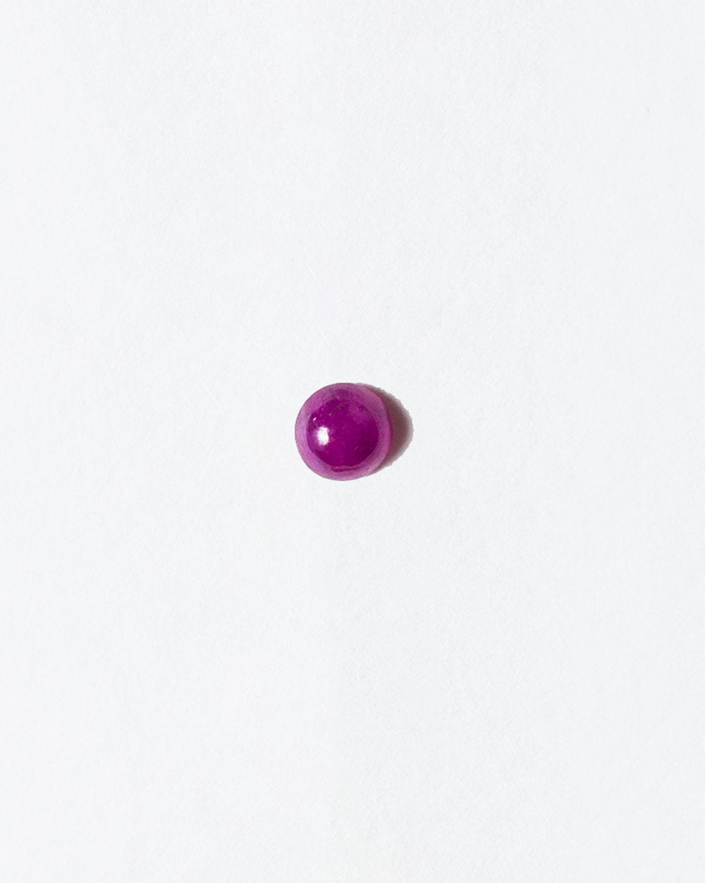 Ruby cabochon on light color background.