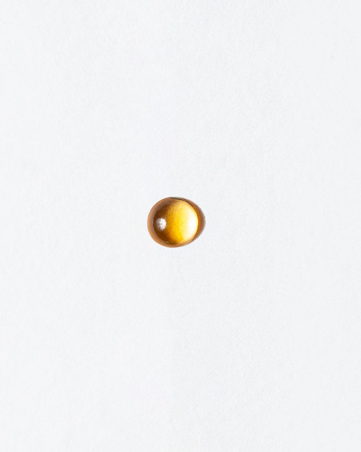 Citrine cabochon on light color background.