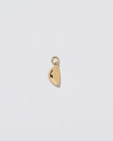 View from the side of the Steamed Dumpling Charm on light color background.