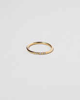 Gold Five Stone Dot Band on light color background.