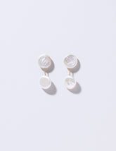 Atlas Earrings on light color background.