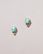 Divine Protection Earrings on light color background.